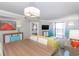 Open-concept living area with dining table, comfortable seating, and balcony access with beach view at 7200 N Ocean Blvd. # 1058, Myrtle Beach, SC 29572