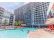 Outdoor pool with sunbathers, lounge chairs, palm trees, and views of the high-rise condo buildings at 7200 N Ocean Blvd. # 1058, Myrtle Beach, SC 29572