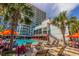 Outdoor pool area with plenty of lounge chairs, palm trees, and a view of the high-rise condo building at 7200 N Ocean Blvd. # 1058, Myrtle Beach, SC 29572