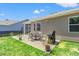Cozy back patio with outdoor seating, grill, and lush lawn, perfect for entertaining and relaxation at 747 Gryffindor Dr., Longs, SC 29568