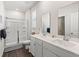 Bright bathroom with a double vanity, framed mirrors, and a glass-enclosed shower at 747 Gryffindor Dr., Longs, SC 29568