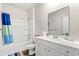 Bright bathroom with a shower-tub combination, a large mirror, and a modern vanity with clean white counter at 747 Gryffindor Dr., Longs, SC 29568