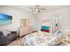 Inviting bedroom with TV, ensuite bathroom, and neutral decor with bright blue accents at 747 Gryffindor Dr., Longs, SC 29568
