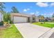 Charming single-story home with a wide driveway, attached garage, and beautifully landscaped front yard at 747 Gryffindor Dr., Longs, SC 29568