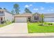 Inviting single-story home featuring an attached garage, manicured lawn, and charming curb appeal at 747 Gryffindor Dr., Longs, SC 29568