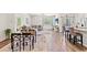 Open-concept living area with a dining table and kitchen island at 747 Gryffindor Dr., Longs, SC 29568