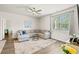 Cozy living room featuring a plush sectional sofa, ceiling fan, and a bright window at 747 Gryffindor Dr., Longs, SC 29568