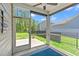 Relaxing screened porch with a view of the backyard and blue accent rug, ideal for enjoying the outdoors at 747 Gryffindor Dr., Longs, SC 29568