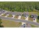 An aerial view of the house showcasing its location in a well-kept neighborhood with mature trees at 847 Flowering Branch Ave., Little River, SC 29566