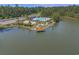 An aerial view of a beautiful lake, community pool, and pavilion surrounded by lush trees and landscaping at 847 Flowering Branch Ave., Little River, SC 29566