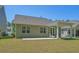 A view of the home's backyard with well maintained lawn, a covered patio and comfortable seating at 847 Flowering Branch Ave., Little River, SC 29566