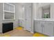 Bright bathroom features double vanity, wood-style tile flooring, and ample natural light at 847 Flowering Branch Ave., Little River, SC 29566