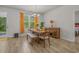 Inviting dining area with a modern chandelier, large windows, and access to the outdoor patio at 847 Flowering Branch Ave., Little River, SC 29566