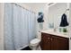 Well-lit bathroom featuring a vanity, mirror, toilet and blue striped shower curtain at 903 Ocean Pines Ct., North Myrtle Beach, SC 29582
