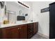 Well-lit bathroom with double vanity, storage cabinets, and decorative mirror at 903 Ocean Pines Ct., North Myrtle Beach, SC 29582