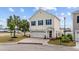 Charming two-story home featuring blue shutters, attached two-car garage, and landscaped front yard at 903 Ocean Pines Ct., North Myrtle Beach, SC 29582