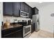 Cozy kitchen with black cabinets, stainless steel appliances, and tile backsplash at 903 Ocean Pines Ct., North Myrtle Beach, SC 29582