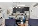 Cozy kitchen with black cabinets, stainless steel appliances, and breakfast bar adjacent to living area at 903 Ocean Pines Ct., North Myrtle Beach, SC 29582