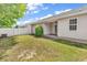A serene backyard featuring a well-maintained lawn, privacy fence, and a cozy patio area at 9616 Sullivan Dr., Murrells Inlet, SC 29576