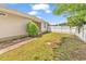 Side view of a house with a beautiful fenced-in backyard and an overgrown lawn at 9616 Sullivan Dr., Murrells Inlet, SC 29576