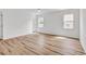 Spacious bedroom with hardwood floors, two windows, and ample natural light at 9616 Sullivan Dr., Murrells Inlet, SC 29576