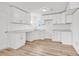 Bright kitchen featuring all white cabinets, countertops, and light wood-look floors at 9616 Sullivan Dr., Murrells Inlet, SC 29576