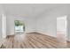 Bright living room with light wood-look floors and glass sliding doors to the backyard at 9616 Sullivan Dr., Murrells Inlet, SC 29576