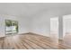 Bright living room with light wood-look floors and glass sliding doors to the backyard at 9616 Sullivan Dr., Murrells Inlet, SC 29576