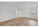 Bright living room featuring light wood-look floors and multiple doorways at 9616 Sullivan Dr., Murrells Inlet, SC 29576