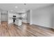 Open concept living and kitchen area featuring wood-look floors, white cabinets, and an island at 1011 Laconic Dr., Myrtle Beach, SC 29588