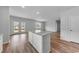Bright kitchen with white cabinets, a gray countertop island, and views of the backyard at 1011 Laconic Dr., Myrtle Beach, SC 29588