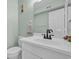Well-lit bathroom featuring a vanity, mirror, and toilet in a clean and modern space at 1011 S Ocean Blvd. # 202, North Myrtle Beach, SC 29582