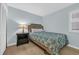 Simple bedroom with a comfortable bed, side table, and neutral color scheme at 1011 S Ocean Blvd. # 202, North Myrtle Beach, SC 29582