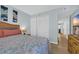 Comfortable bedroom features coastal decor, light blue walls, and a flatscreen television at 1011 S Ocean Blvd. # 202, North Myrtle Beach, SC 29582