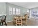 Bright dining area featuring a round table, shuttered windows, and easy access to the outdoor balcony at 1011 S Ocean Blvd. # 202, North Myrtle Beach, SC 29582
