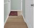 Hallway has light wood floors with a 'welcome' door mat at the entrance at 1011 S Ocean Blvd. # 202, North Myrtle Beach, SC 29582