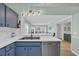 Kitchen with a breakfast bar overlooking a light and airy living space with comfortable seating at 1011 S Ocean Blvd. # 202, North Myrtle Beach, SC 29582