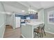 Spacious kitchen featuring blue cabinets, white countertops, and seating at the breakfast bar at 1011 S Ocean Blvd. # 202, North Myrtle Beach, SC 29582