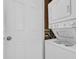 Laundry area featuring a stacked washer and dryer with easy-to-read operating instructions at 1011 S Ocean Blvd. # 202, North Myrtle Beach, SC 29582