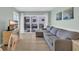 Comfortable living room with a sectional sofa and sliding glass doors leading to the balcony at 1011 S Ocean Blvd. # 202, North Myrtle Beach, SC 29582