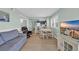 Open living space with dining area, comfortable seating, and views of the kitchen and entertainment center at 1011 S Ocean Blvd. # 202, North Myrtle Beach, SC 29582