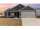Charming single-Gathering home features gray siding, attached garage and well-manicured lawn at 1013 Woodside Dr., Conway, SC 29526