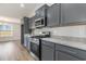 Kitchen with stainless appliances, granite counters, gray cabinets and breakfast bar overlooking the dining area at 1013 Woodside Dr., Conway, SC 29526