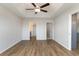 The spacious main bedroom features hardwood floors, a tray ceiling with fan, and access to the bathroom and walk-in closet at 1013 Woodside Dr., Conway, SC 29526