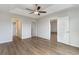 The main bedroom features hardwood floors, a tray ceiling with fan, and access to the bathroom and walk-in closet at 1013 Woodside Dr., Conway, SC 29526