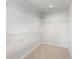 A walk-in closet featuring carpeted floors and adjustable white wire shelving at 1013 Woodside Dr., Conway, SC 29526