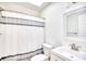 Bright bathroom with a shower curtain, sink and vanity, toilet, and modern mirror at 1023 S Sea Bridge Ct., Surfside Beach, SC 29575