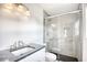 Modern bathroom featuring a glass-enclosed shower with stylish gray tile and black hexagon flooring at 1023 S Sea Bridge Ct., Surfside Beach, SC 29575