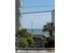 Easy beach access with stairs leading to the ocean, surrounded by lush greenery and glimpses of neighborhood buildings at 1023 S Sea Bridge Ct., Surfside Beach, SC 29575