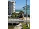 Charming beachside home with stairs leading to sandy shores and ocean views, nestled near modern buildings at 1023 S Sea Bridge Ct., Surfside Beach, SC 29575